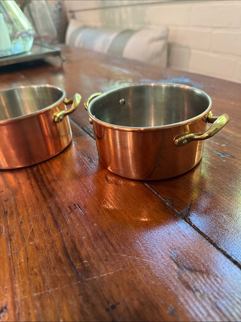 Two small copper pots with brass handles